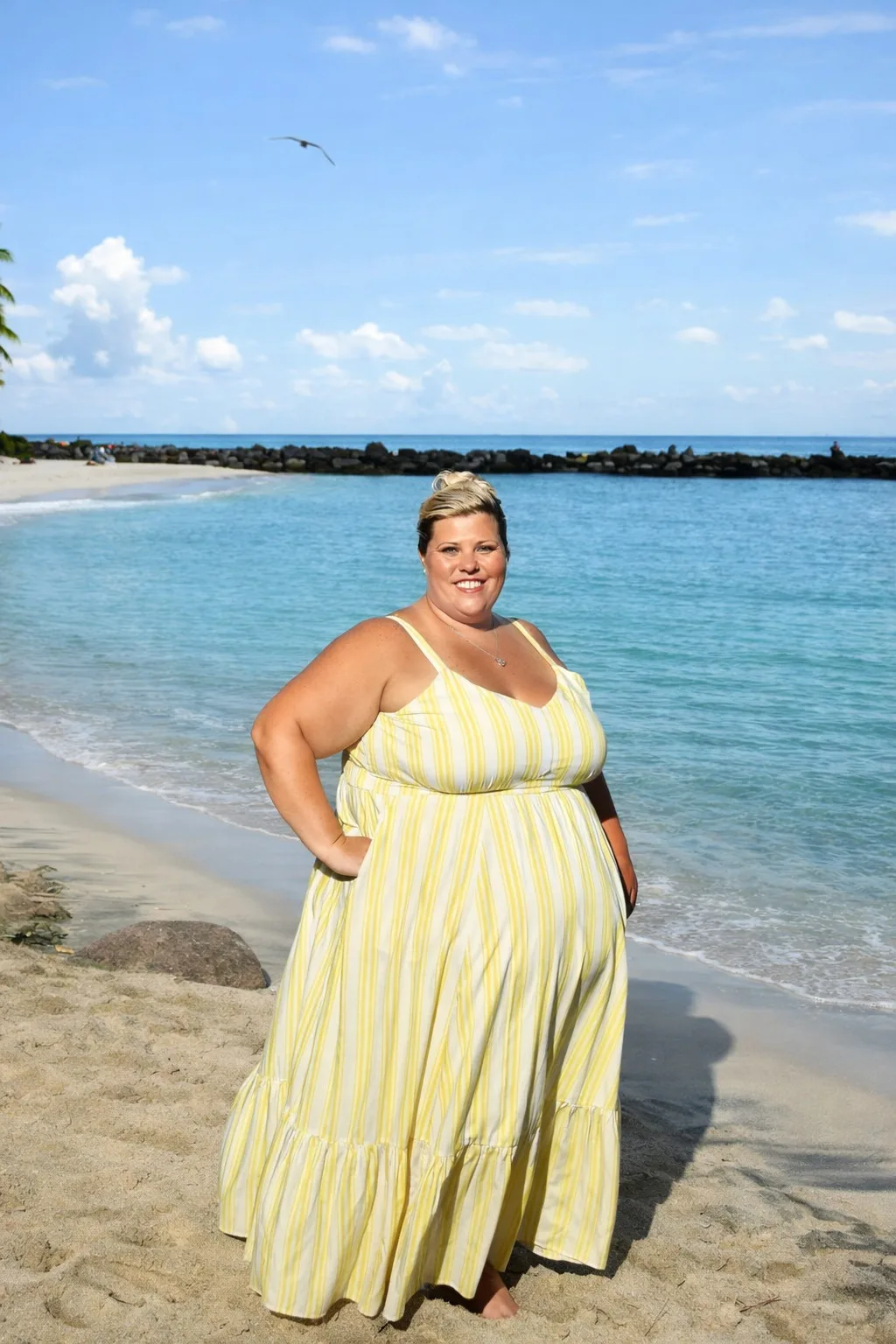 Smiling Natasha Taylor on a beach getaway